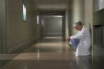 doctor sitting in hospital hallway