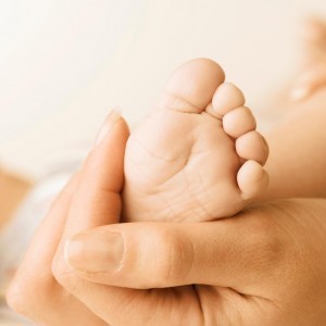 baby foot in adult hand