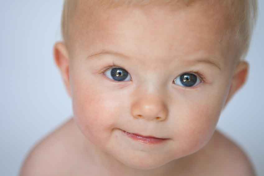 close up of baby's smiling face