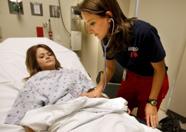 triage nurse with patient in ER