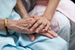elderly woman's hand and child's hand